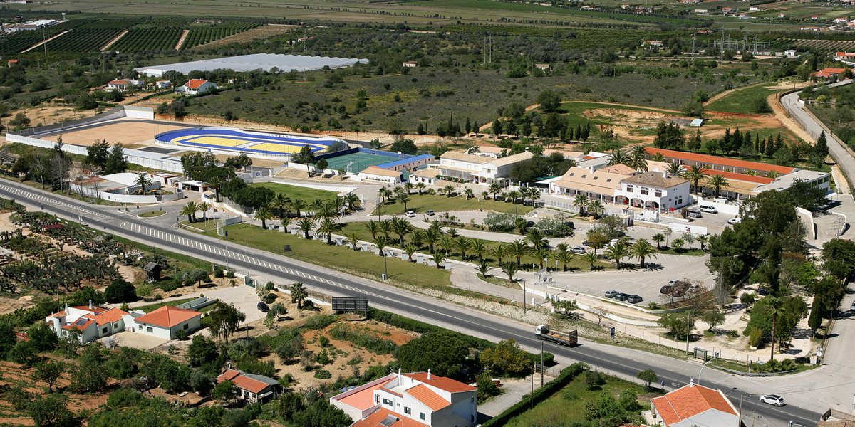 Aerial view of Algarve highway with whitewashed buildings, farms and countryside