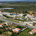 Aerial view of Algarve highway with whitewashed buildings, farms and countryside