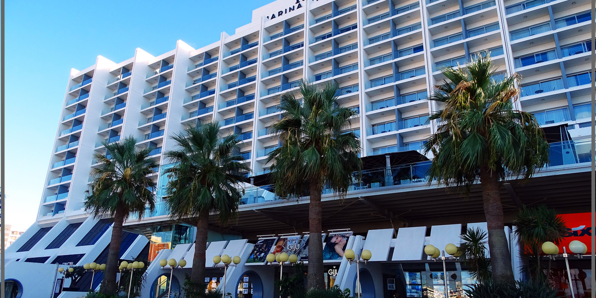 Tivoli Marina Vilamoura hotel exterior with palm trees and modern white architecture